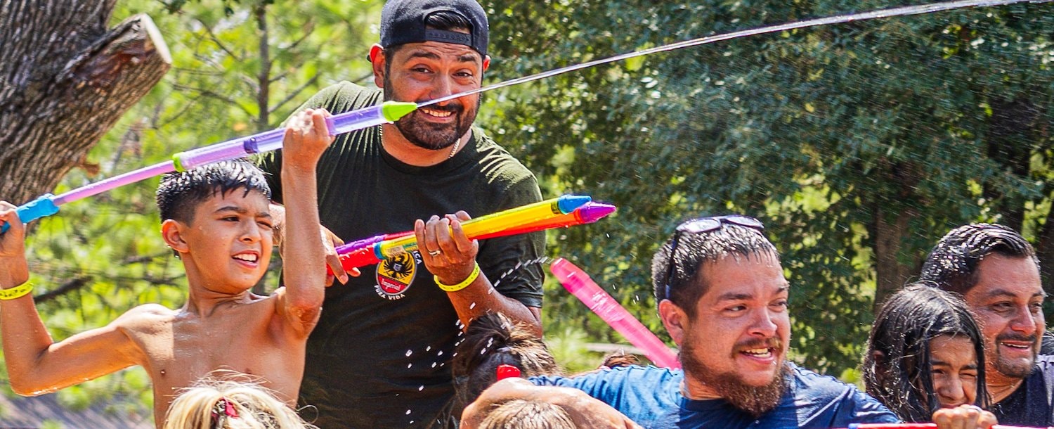 A group of people with water guns at Jellystone Park™ North Texas