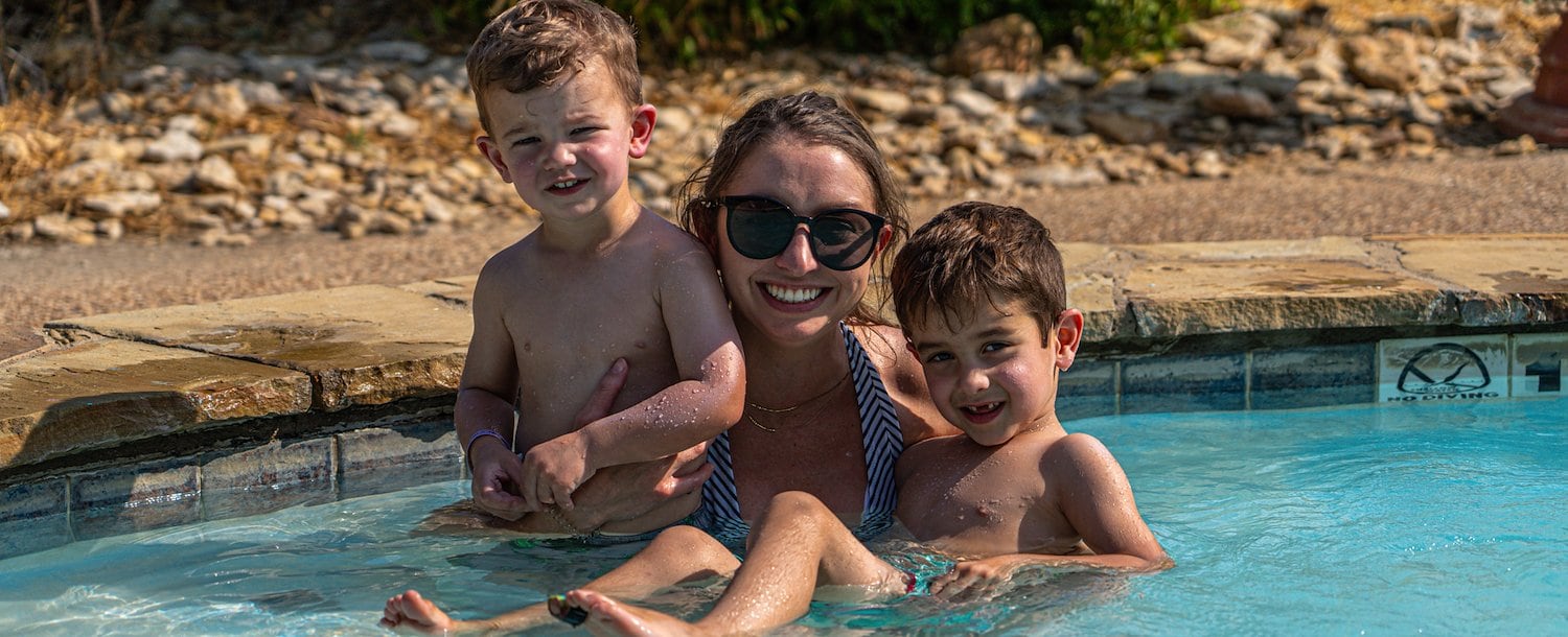 Mom and sons enjoying pool at Jellystone Park™ North Texas