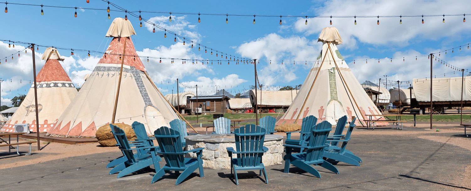 Tipi and fire pit at Jellystone Park™ North Texas