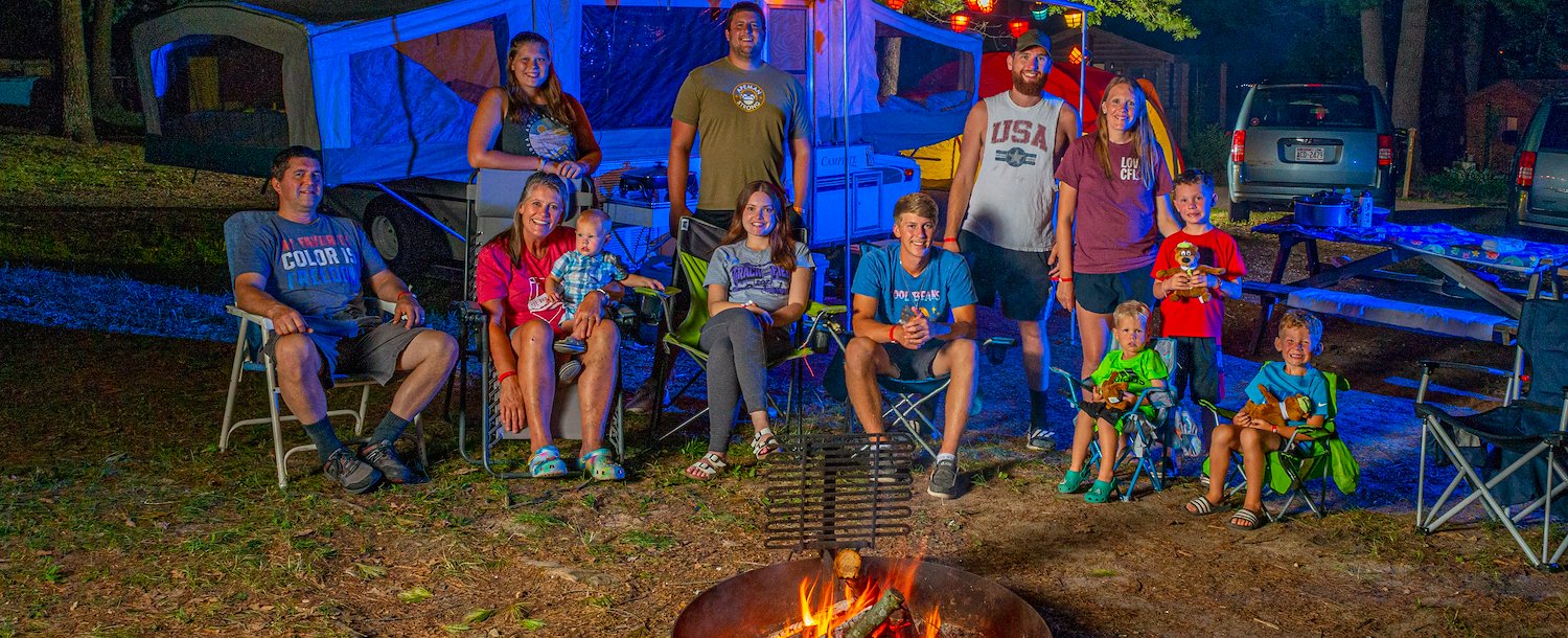 Jellystone Park™ Warrens Group Around Campfire