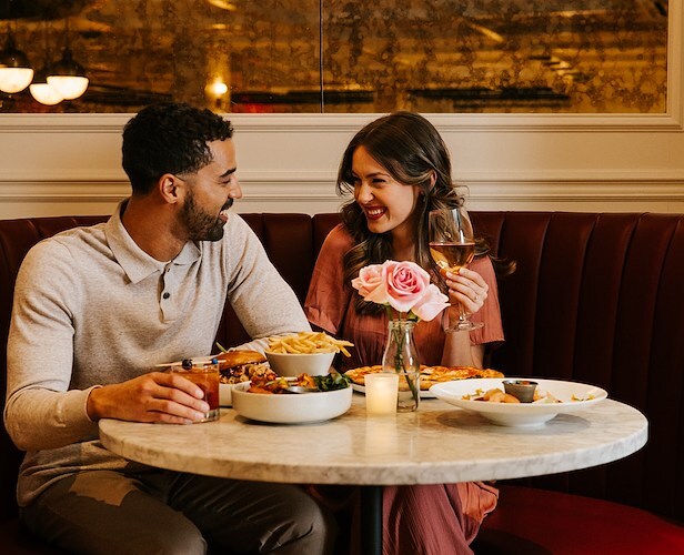 Dining at Canopy by Hilton Boston Downtown features delicious pizza and fries.