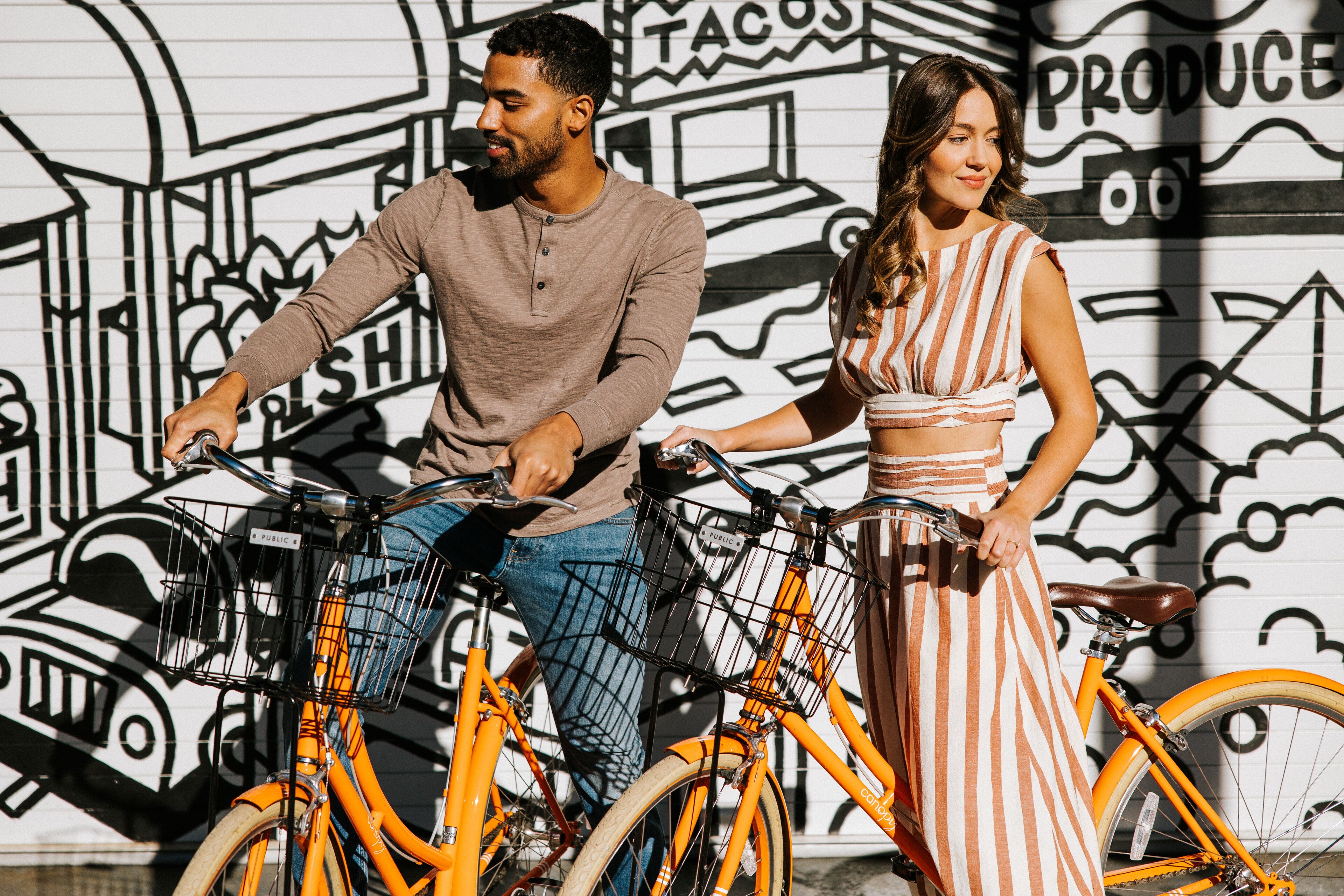 A couple with bikes enjoys the vibrant streets near Canopy by Hilton Boston Downtown