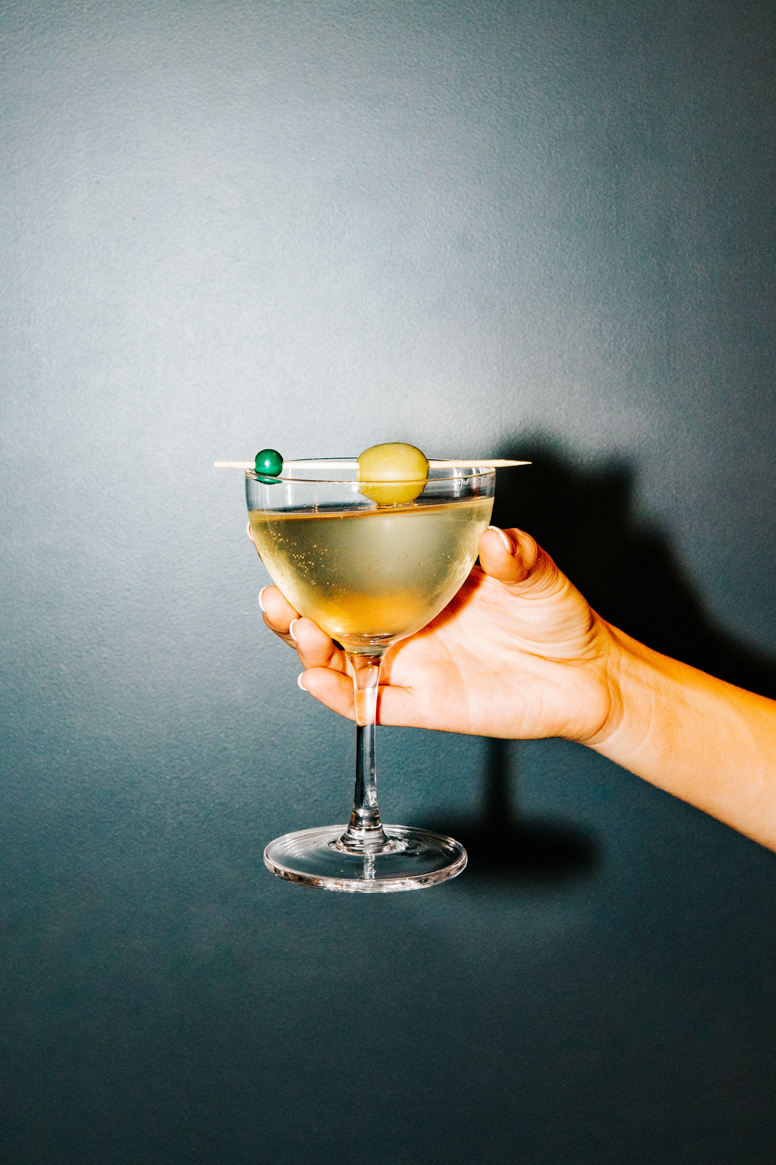A hand holds a cocktail at Canopy by Hilton Boston Downtown