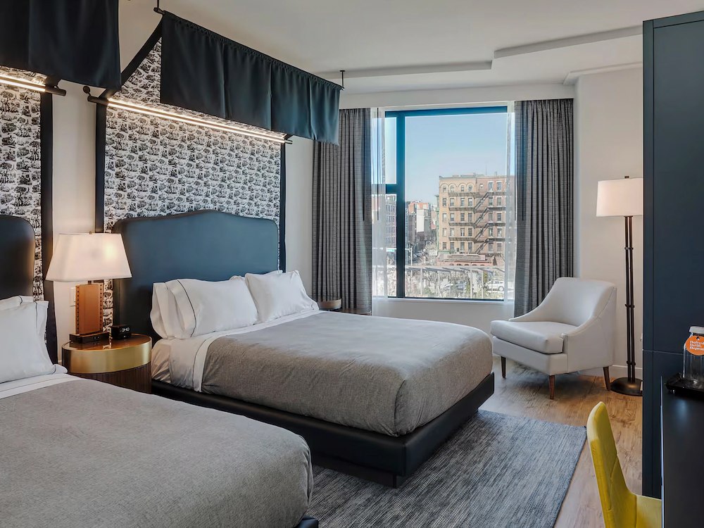 Guest room with two beds with city view at Canopy by Hilton Boston Downtown, MA.