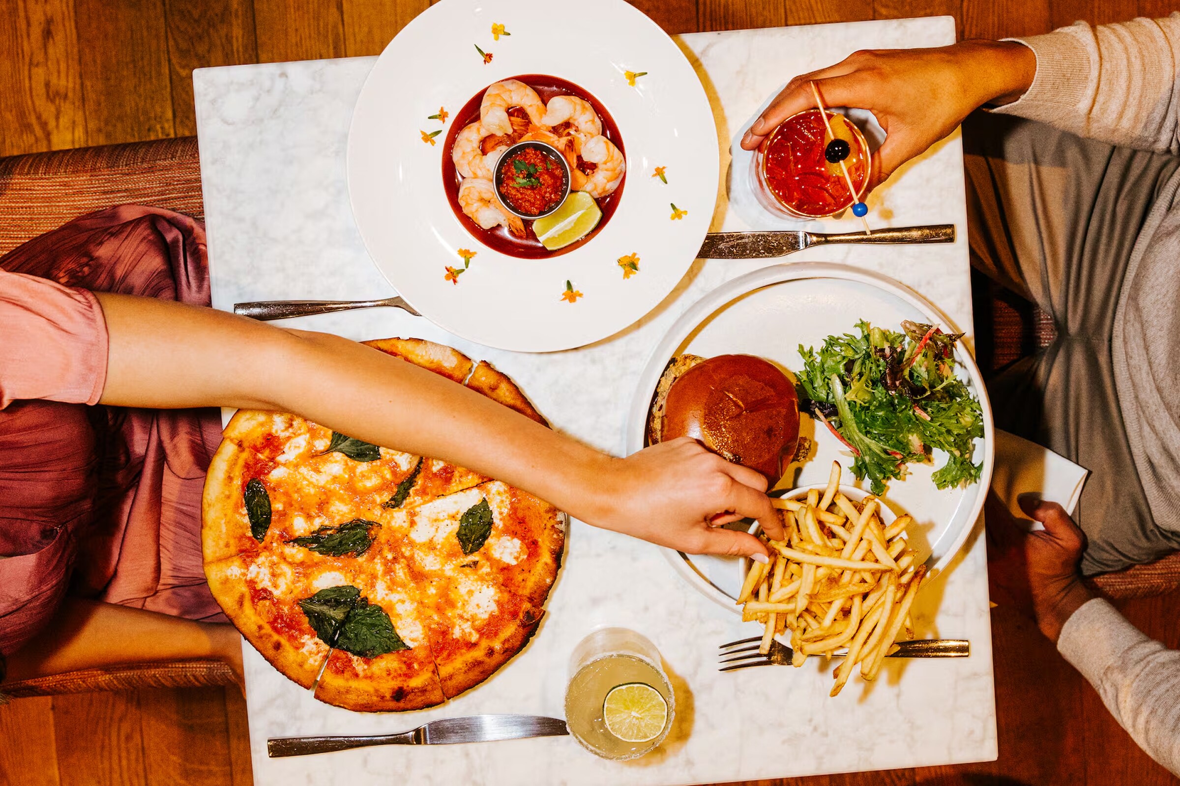 Dining table with pizza at Canopy by Hilton Boston Downtown, MA.