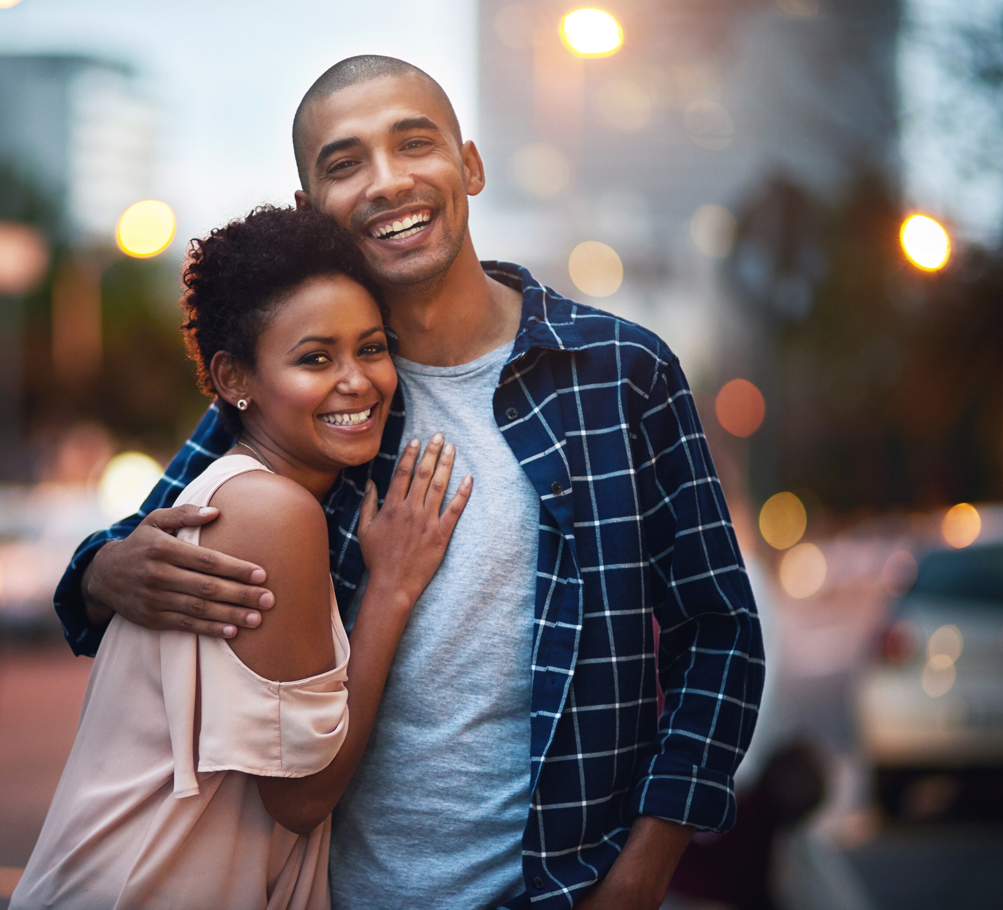 Happy couple embracing and smiling together.