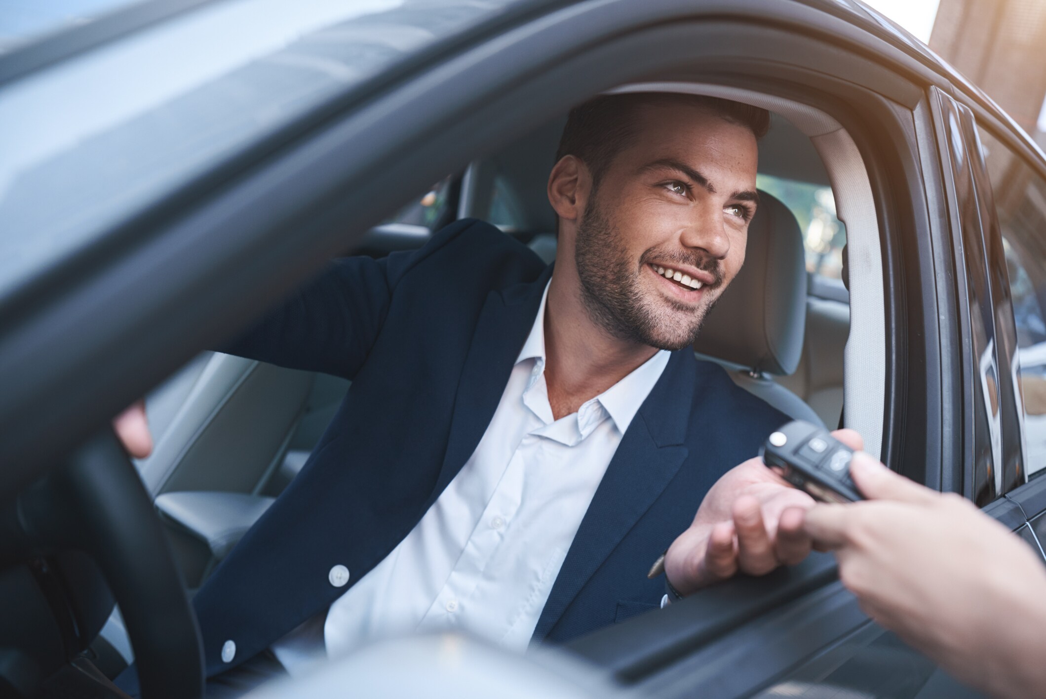 A man smiles from a car at Canopy by Hilton Boston Downtown.