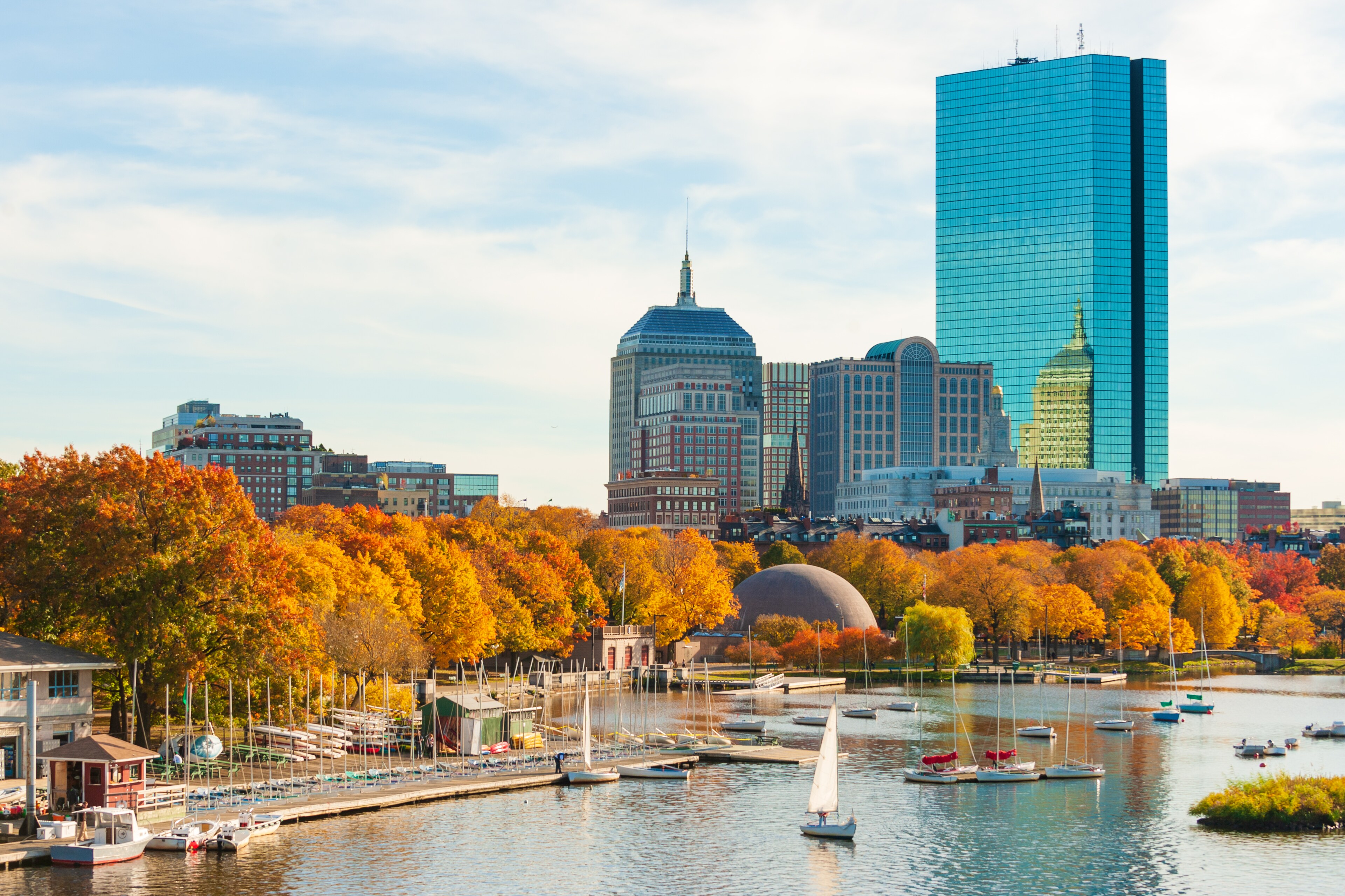 Autumn view of the Boston skyline and sailboats on the Charles River in Boston, MA.