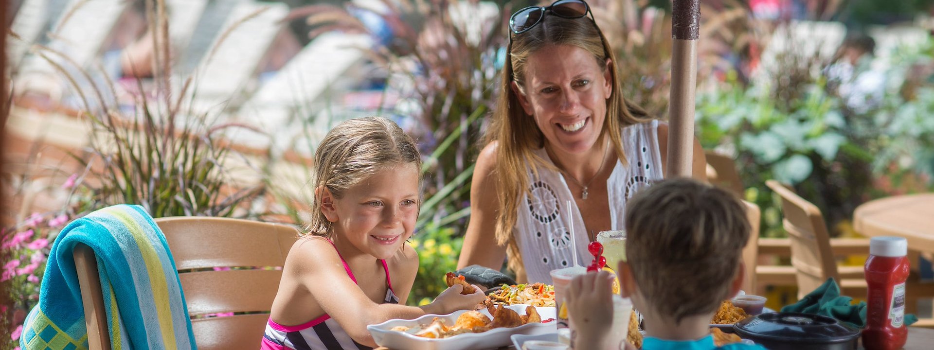 Enjoy a meal at an outdoor table under an umbrella at Chula Vista Resort, Wisconsin Dells, Wisconsin