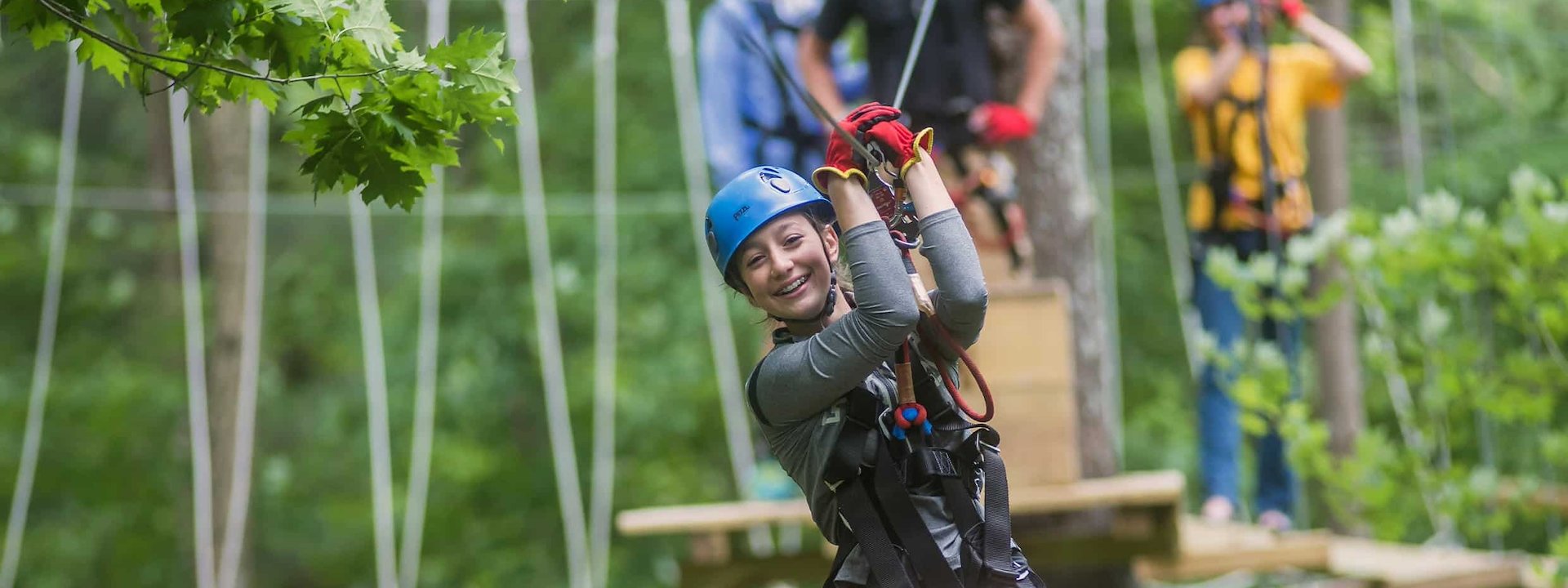 A woman is ziplining on a rope course, Chula Vista Resort, Wisconsin Dells, Wisconsin
