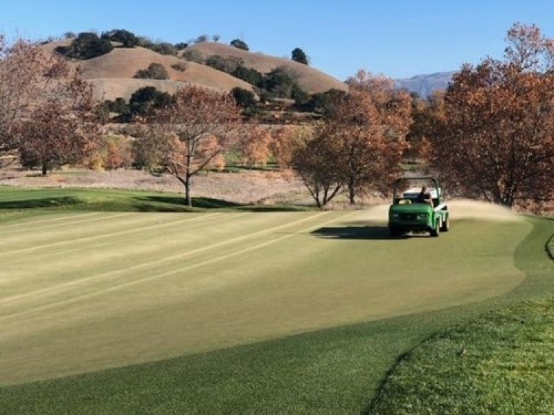A green tractor on a road