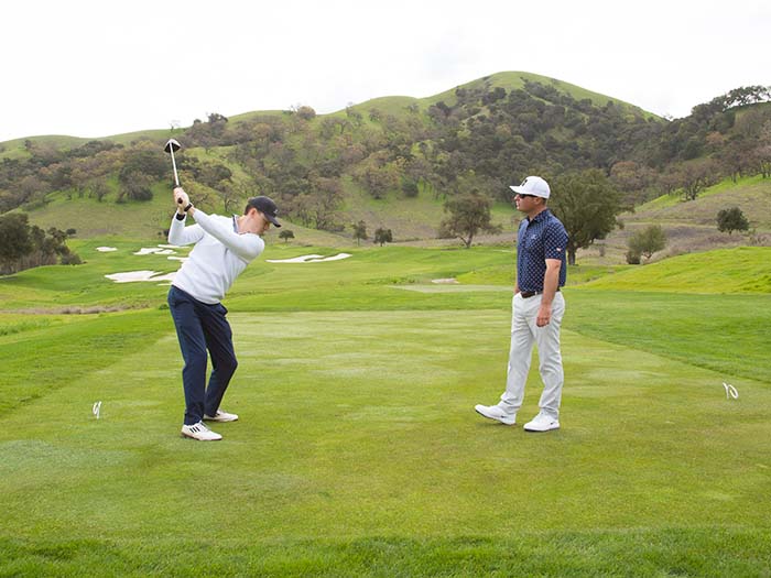 A couple of men playing golf