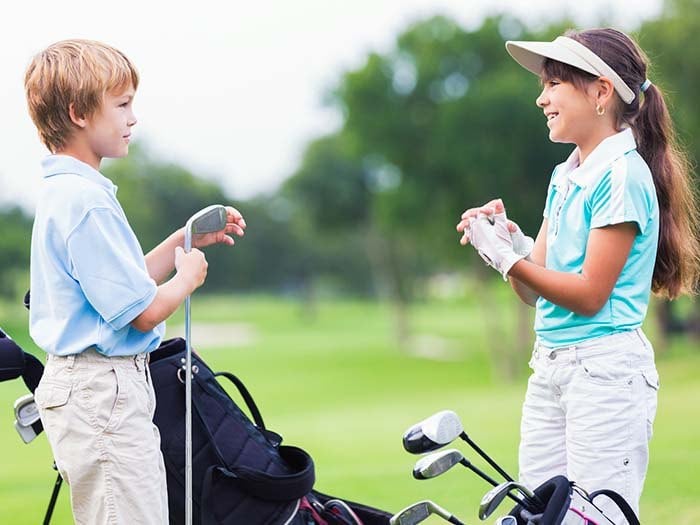 Boy and Girl playing golf at cordevalle usa