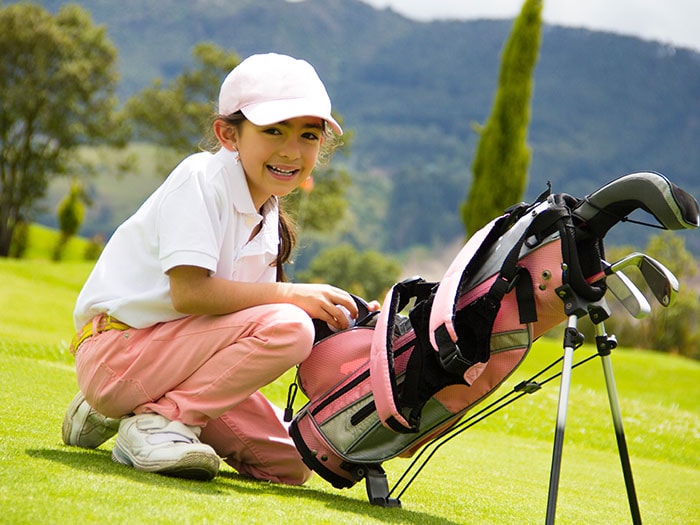 A girl sitting on a golf course