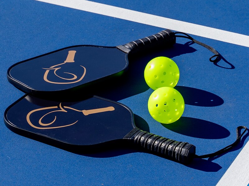 Paddles and balls on a blue surface