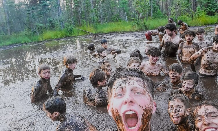 A group of people covered in mud