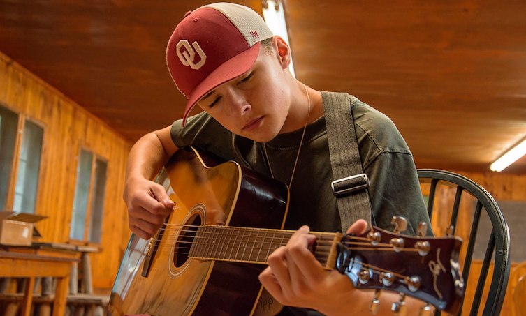 Camper playing guitar