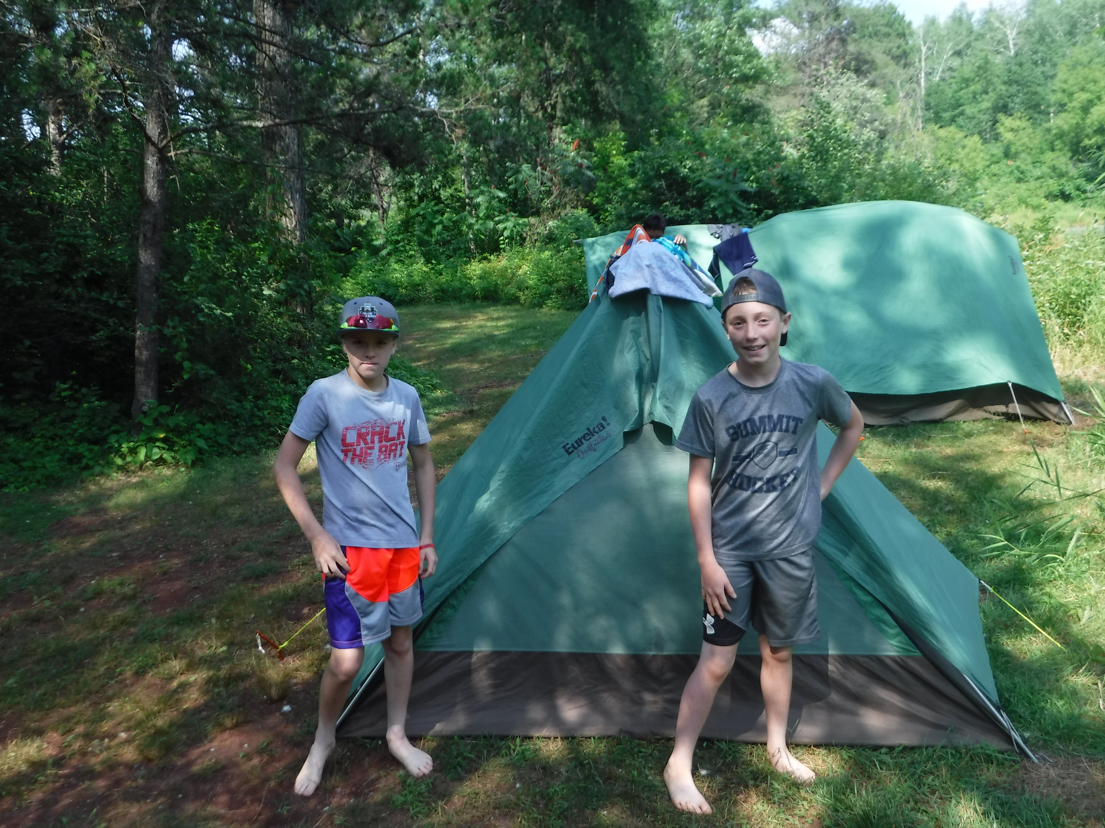 Two boys standing in front of a tent