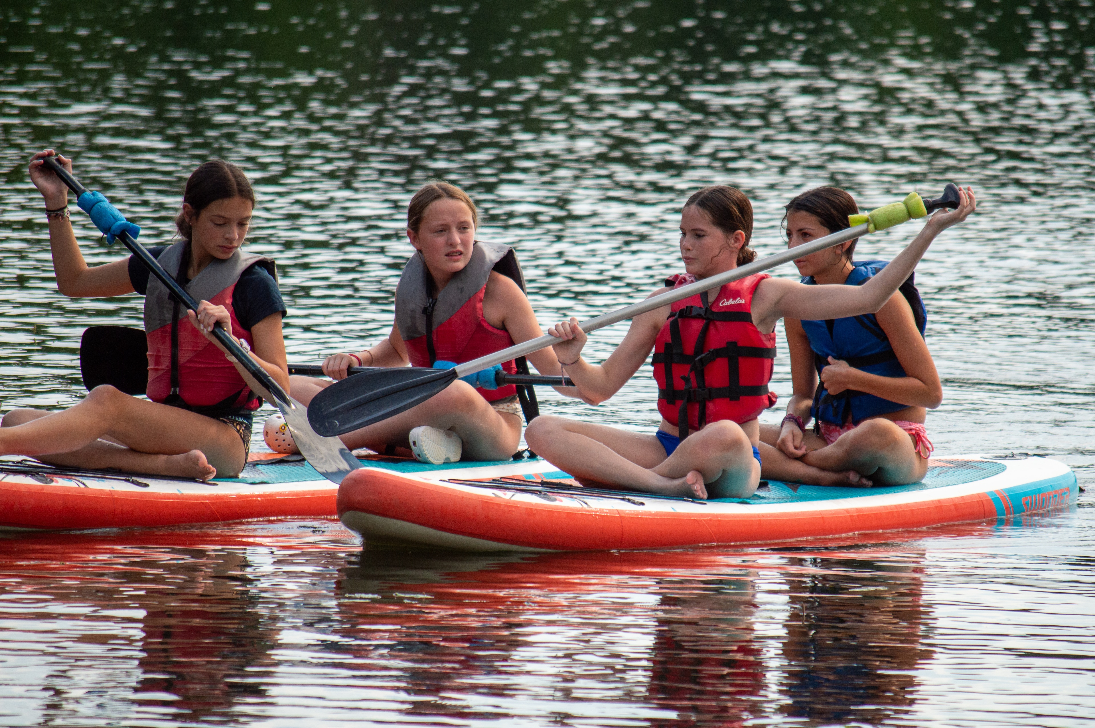 A group of girls on paddle boards on Lake Hubert