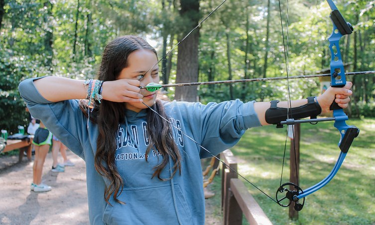 A girl shooting a bow and arrow