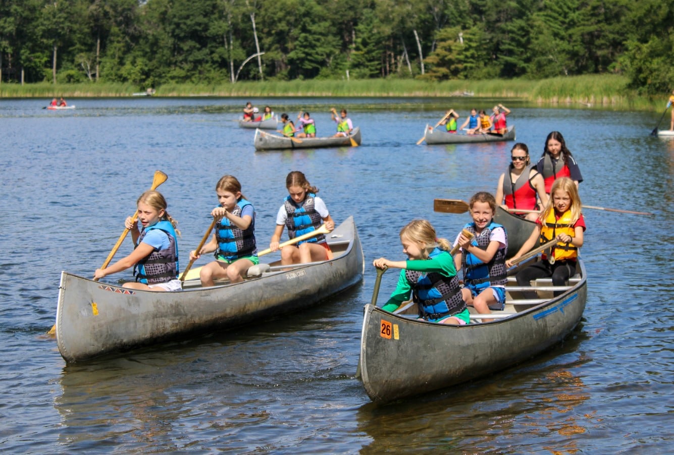 A group of people in canoes on a lake