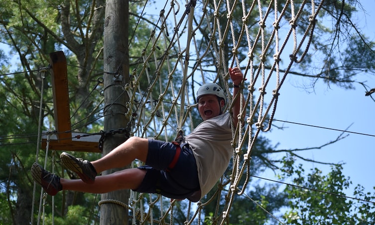 A boy in a helmet on a rope net