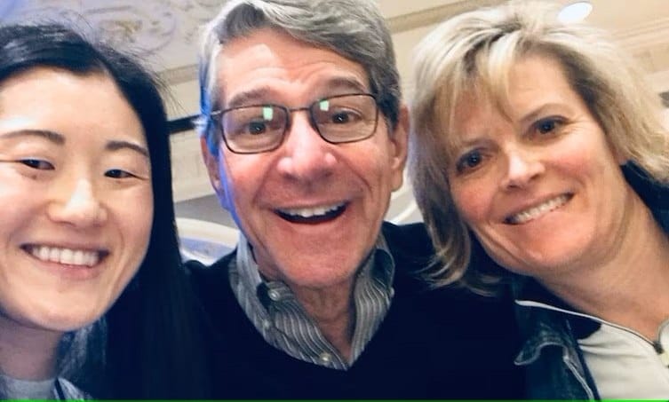People smiling for a close-up selfie indoors