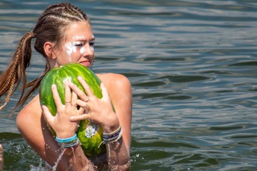 Camp Lake Hubert camper playing fun games in the water playing pass the watermelon