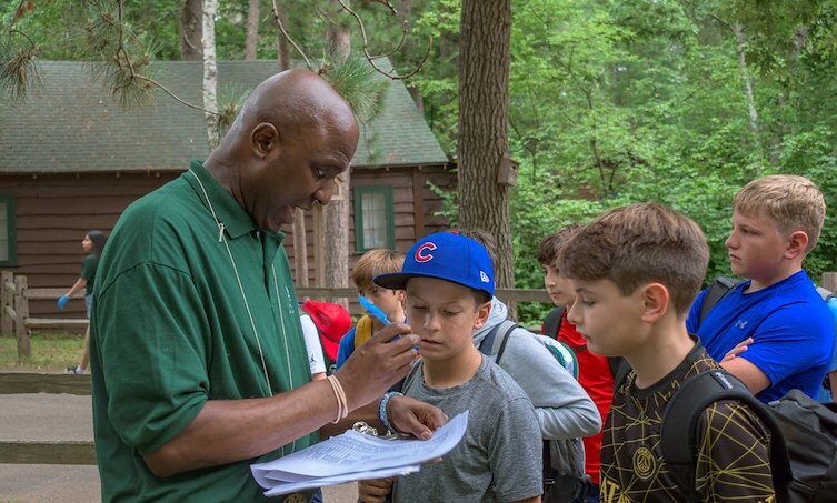andre helping campers on the first day of camp