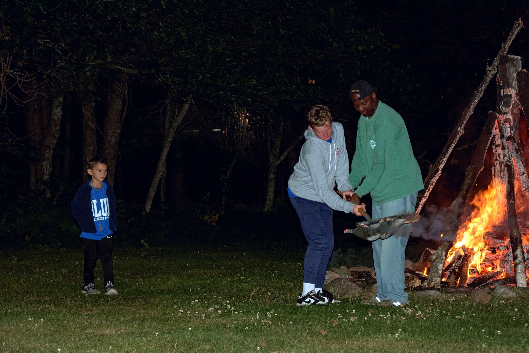 A group of people standing around a fire