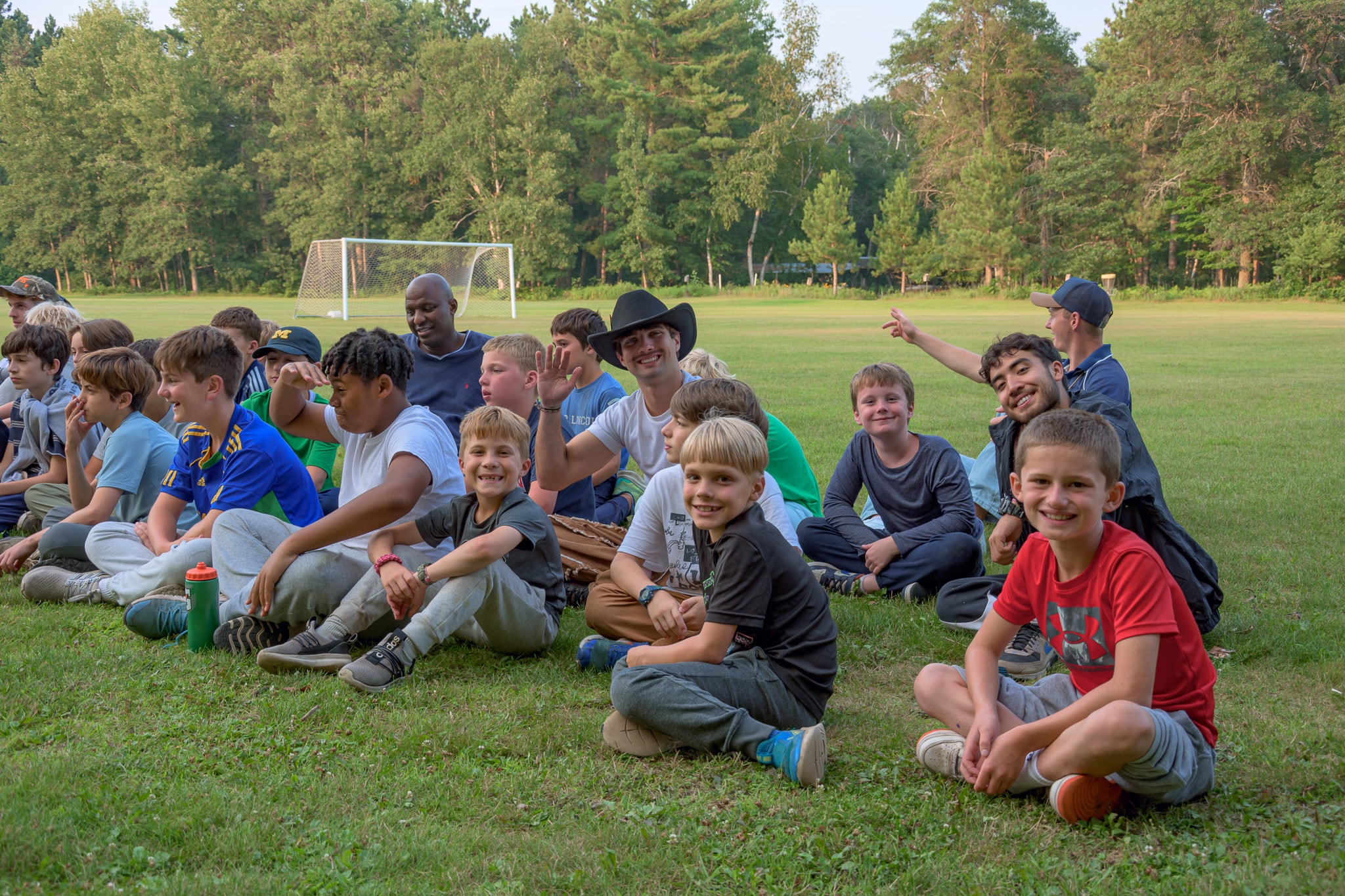 A group of people sitting on grass