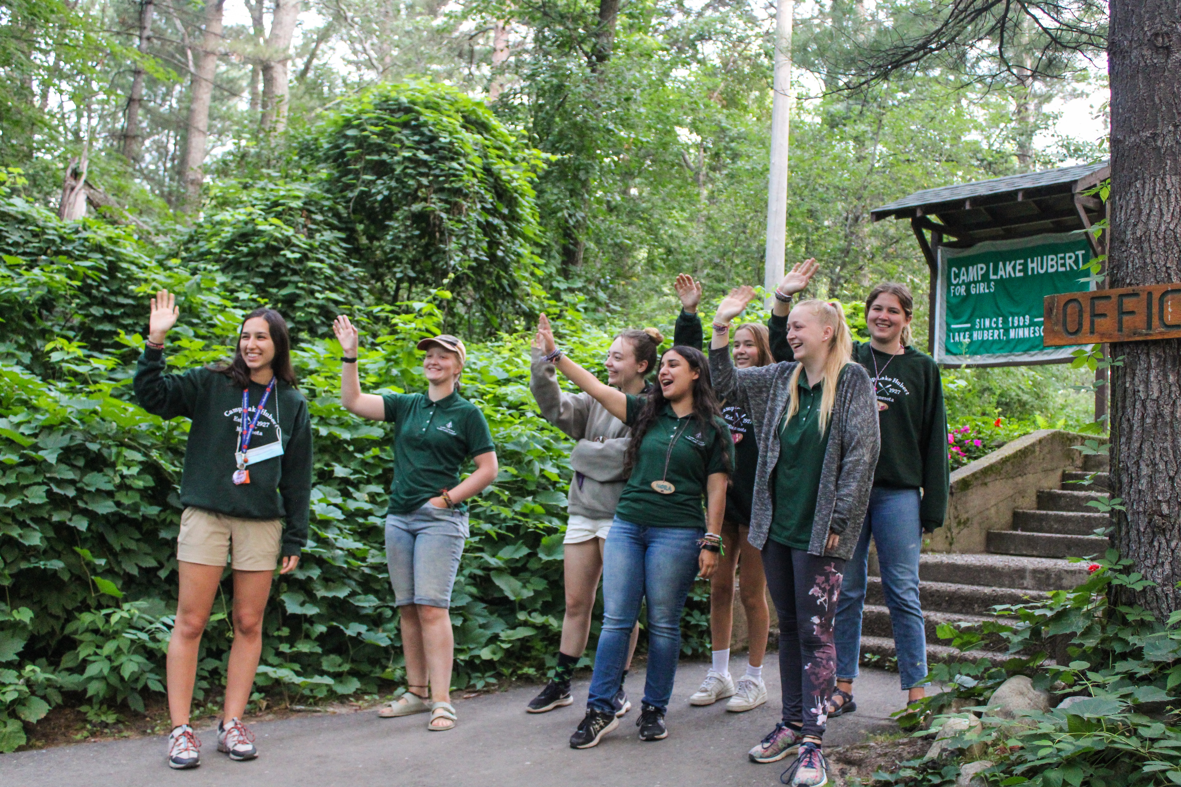 A group of people standing on a path with their hands up