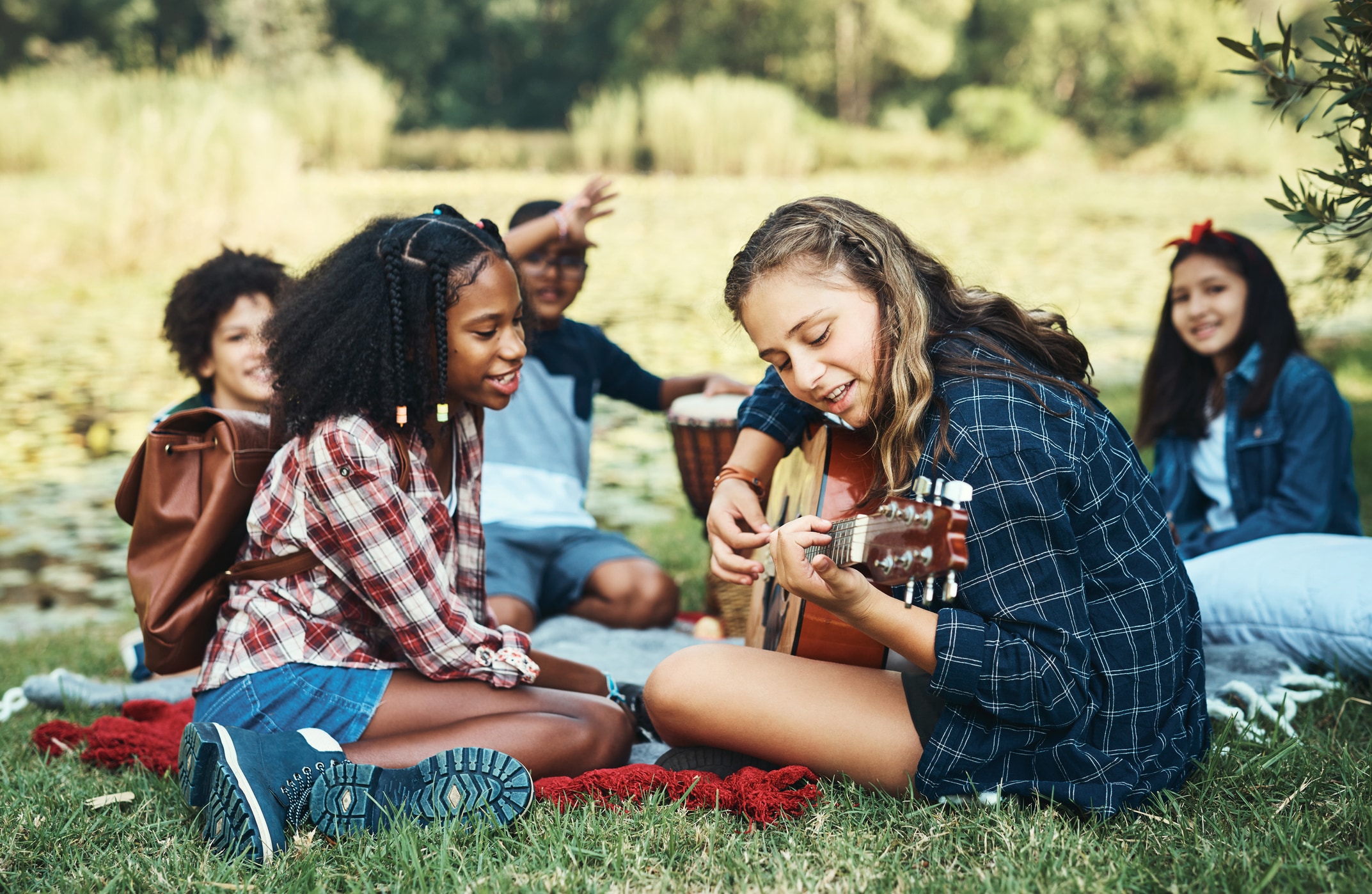 Camp Lake Hubert for Girls enjoying playing guitar and singing