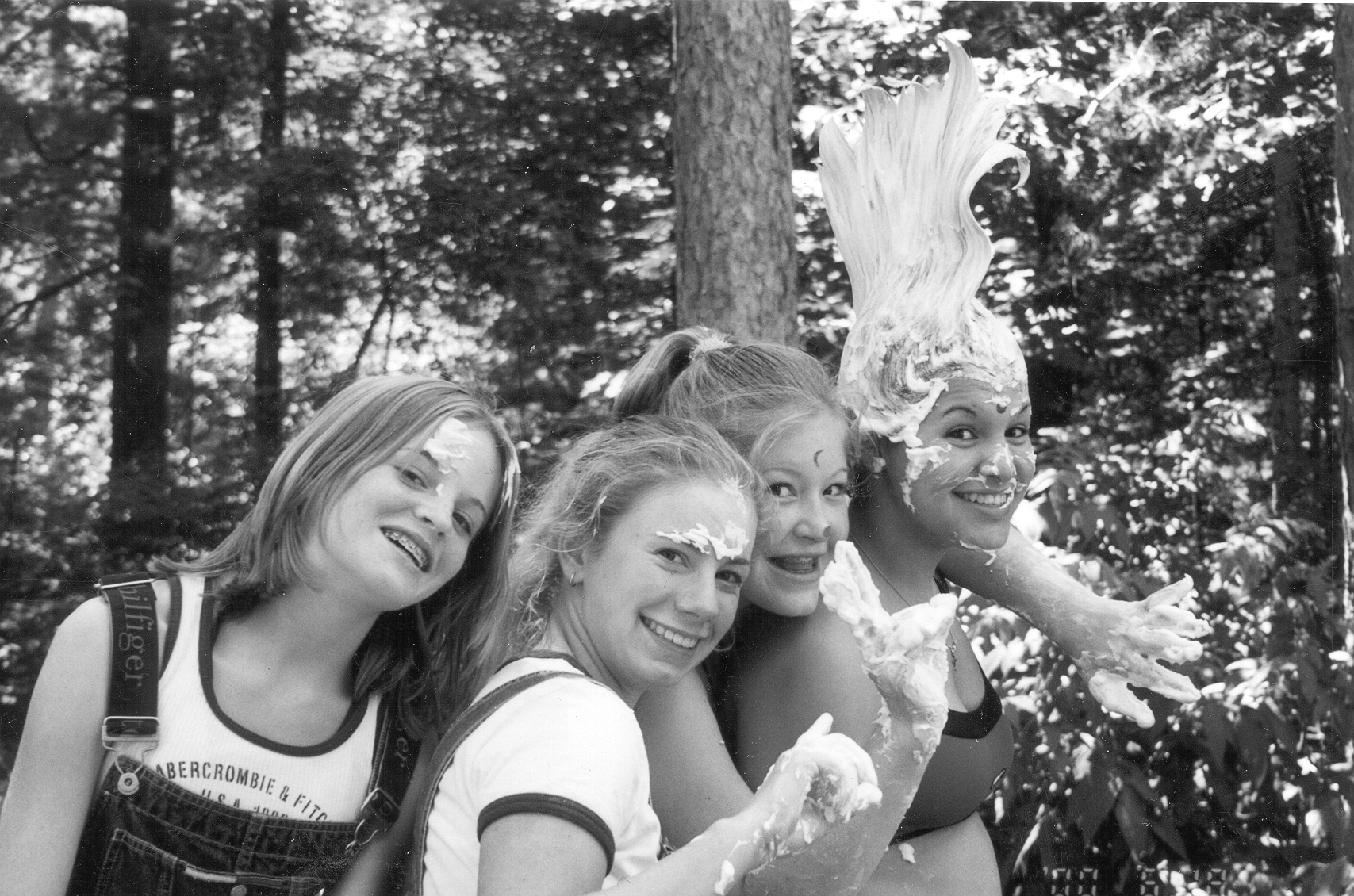 A group of girls with white cream on their faces
