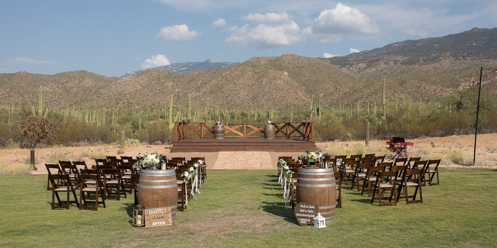 An outdoor event space with a stage, seating, and desert landscape