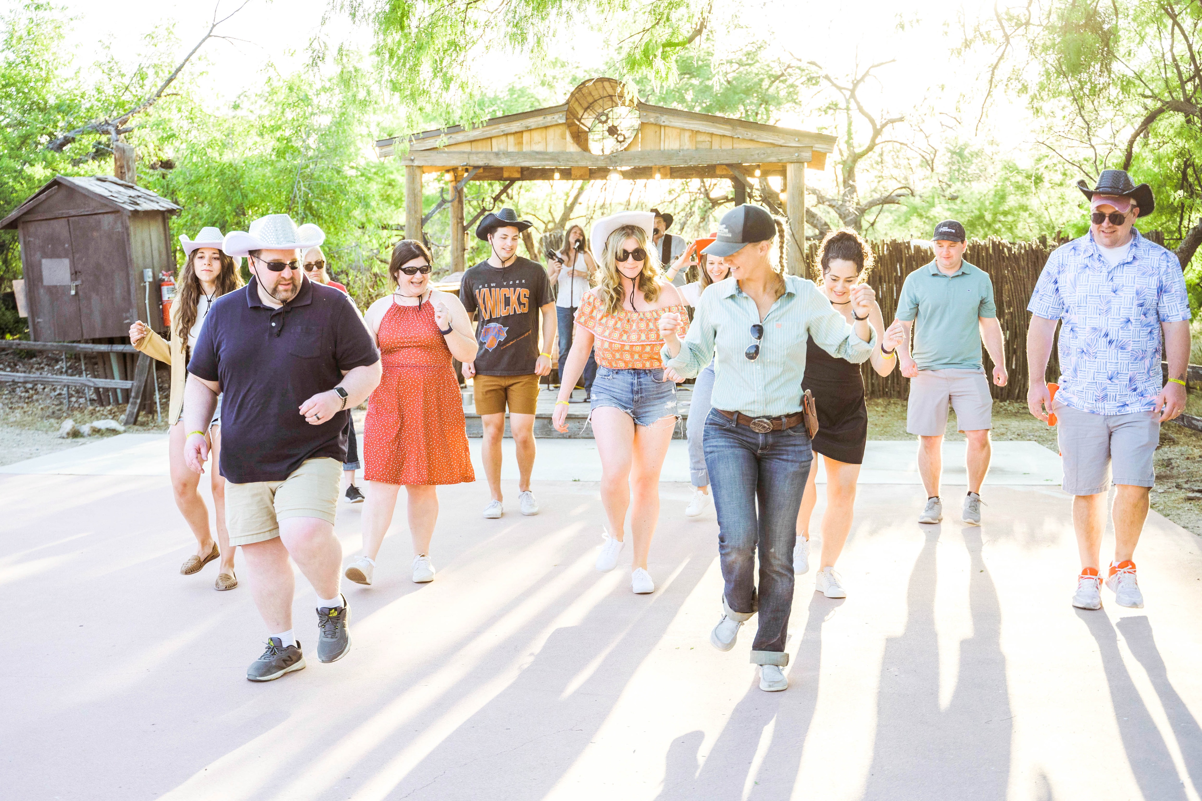 A group of people line dancing at a cookout