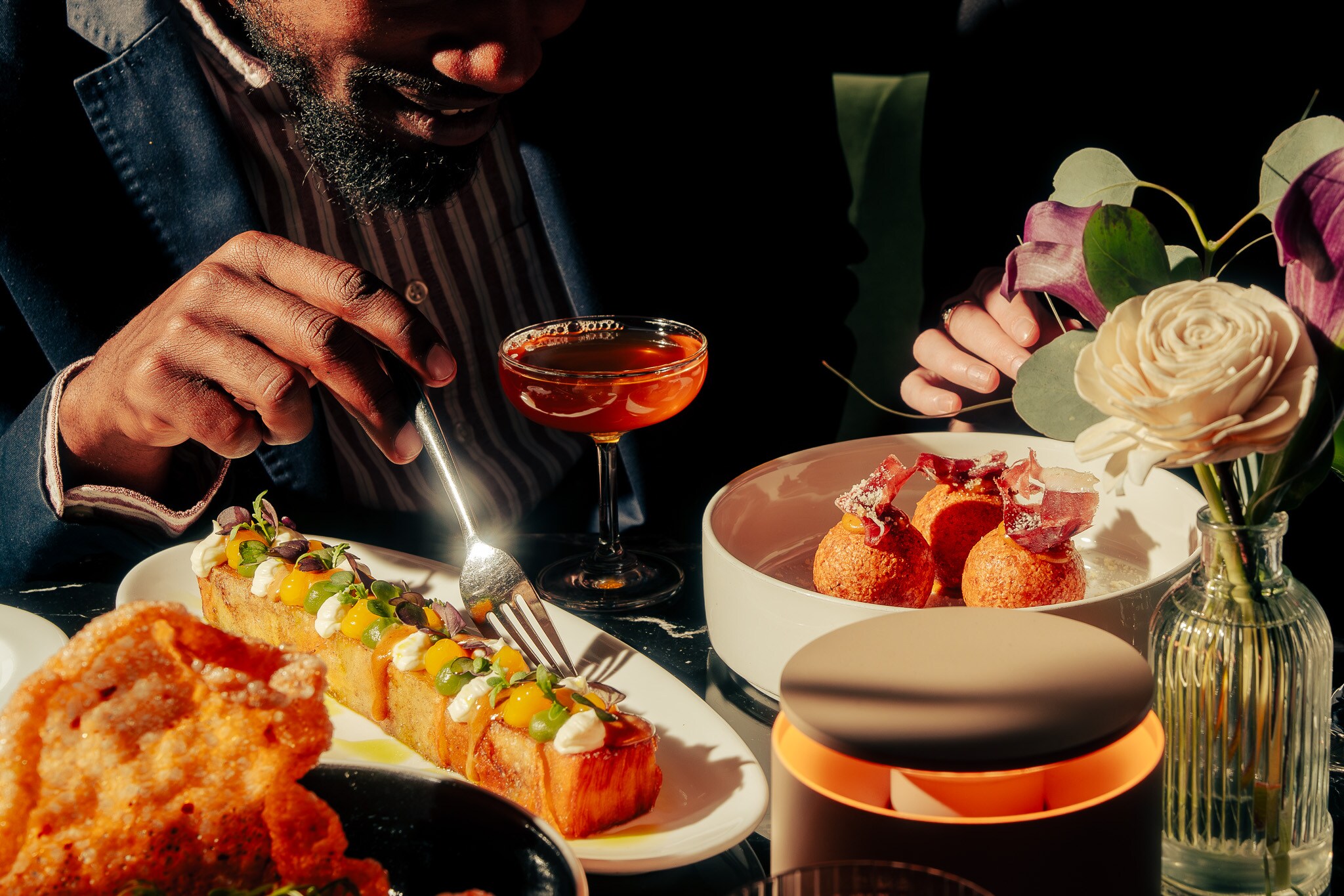 A man is eating food at a table with plates of food, Nova Lounge at Vast, Oklahoma