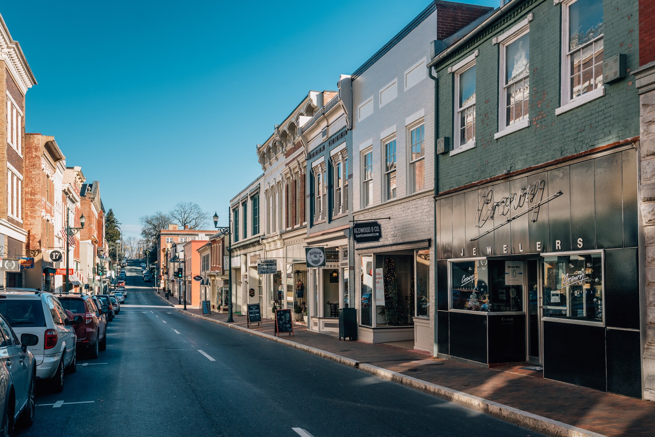 A street with cars parked on both sides of the road