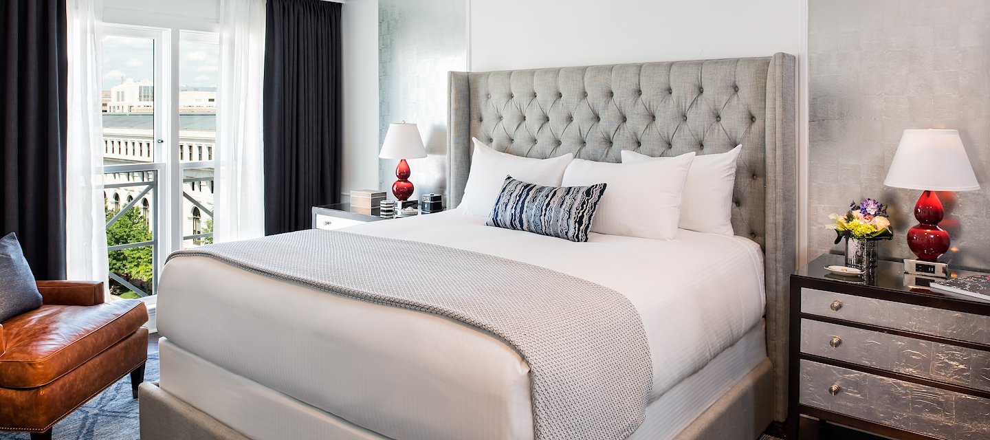 Phoenix Park Hotel Clare Suite showcasing a comfortable bed with high-end bedding and warm tones