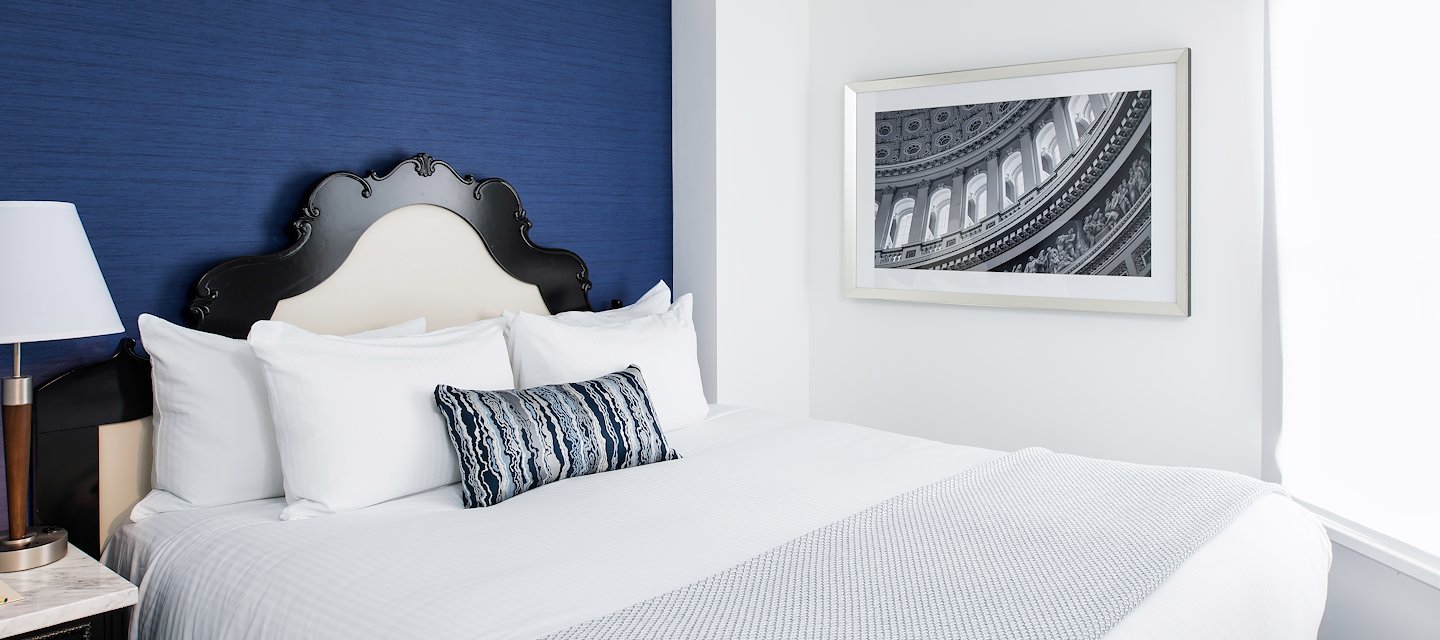 Spacious guest room at Phoenix Park Hotel with plush bedding and traditional décor