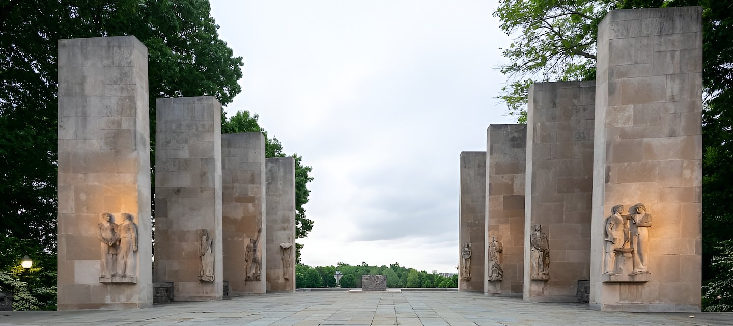 Virginia Tech War Memorial Pylons featuring tall stone pillars with illuminated carvings