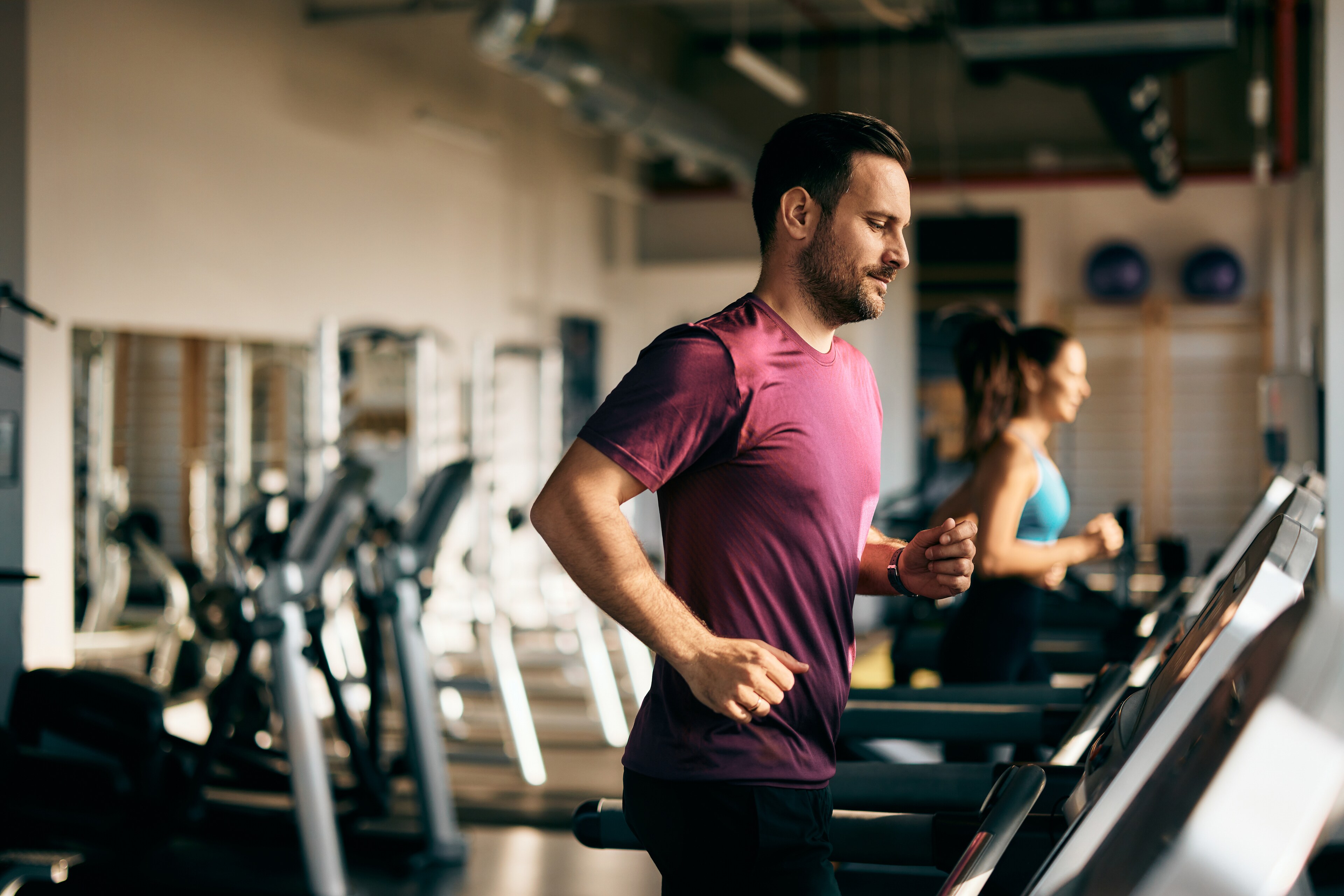 A man and woman jog on treadmills at Brij Medical Centre in Kavi Nagar.
