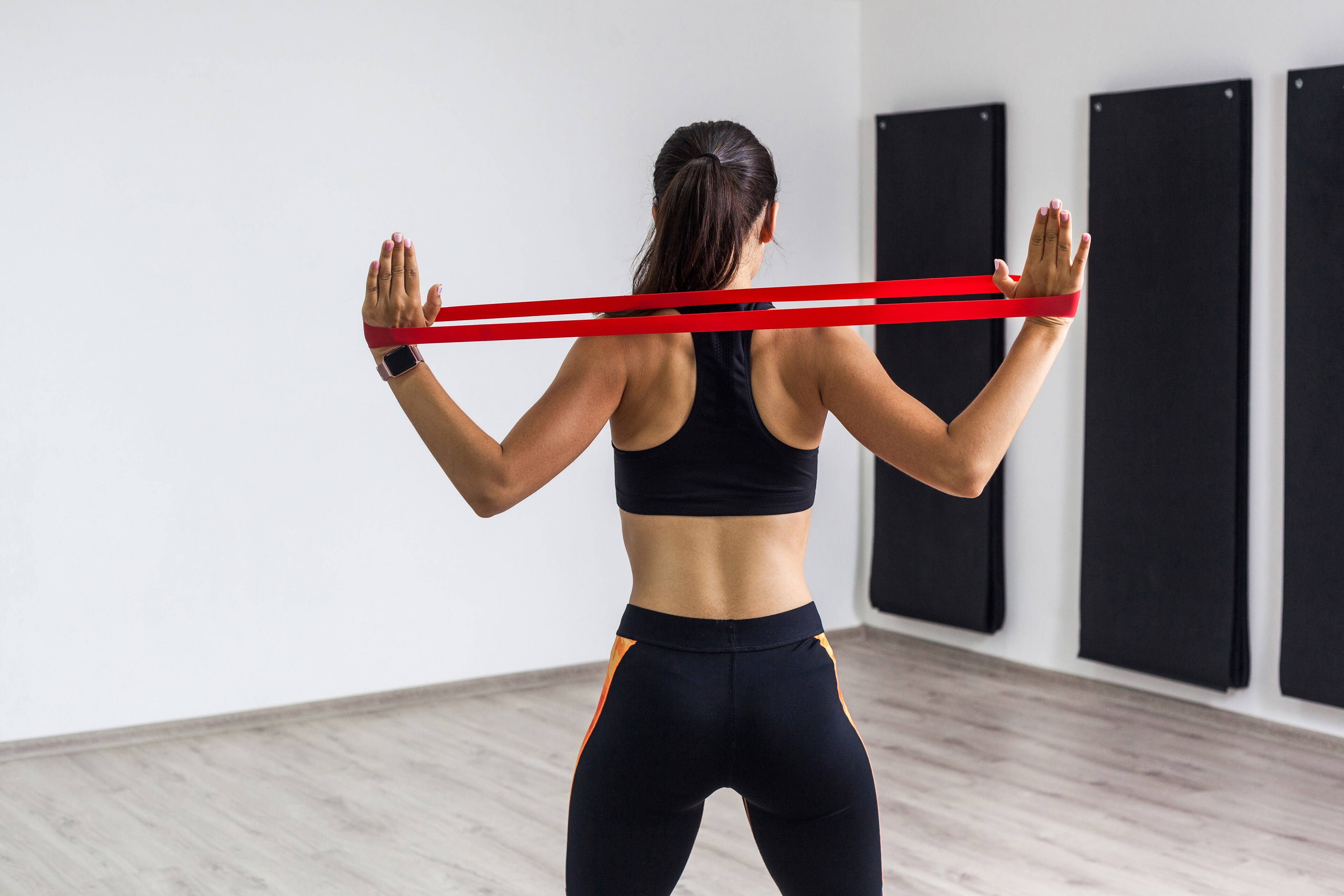 A woman exercises with resistance bands at Brij Medical Centre.