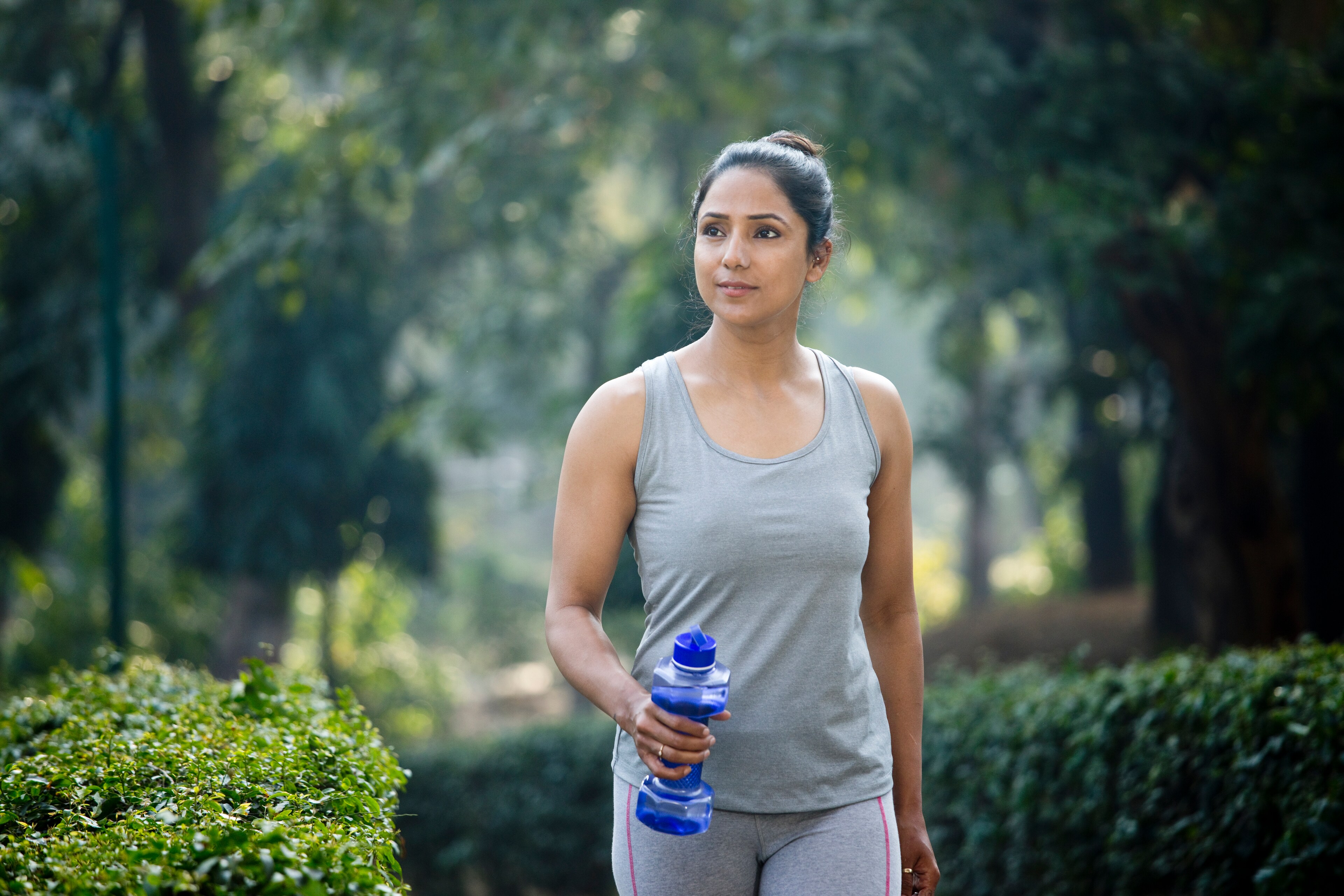 A woman holds a water bottle while jogging near Brij Medical Centre in UP.
