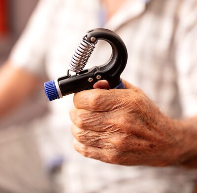 Close-up of a senior man holding a hand grip