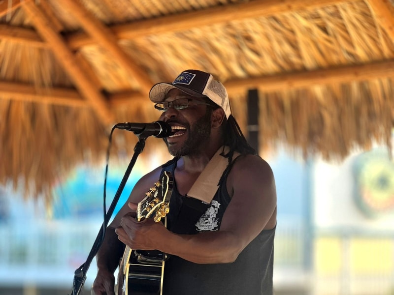 Male musician playing guitar at 
