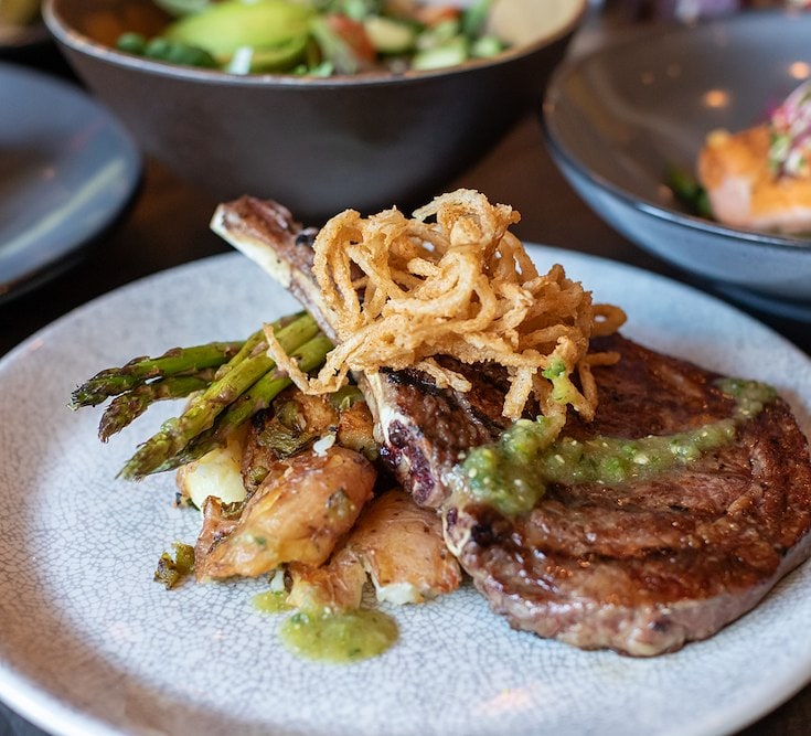 Filet topped with fried onions, served with asparagus at The Henley in Southlake, TX.