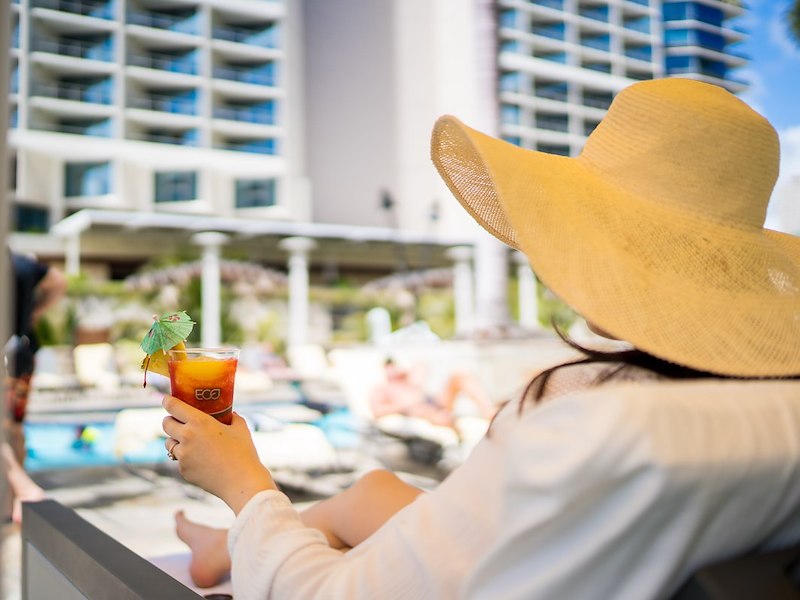 Woman in Daybed on Grand Lanai with Tropical Cockail