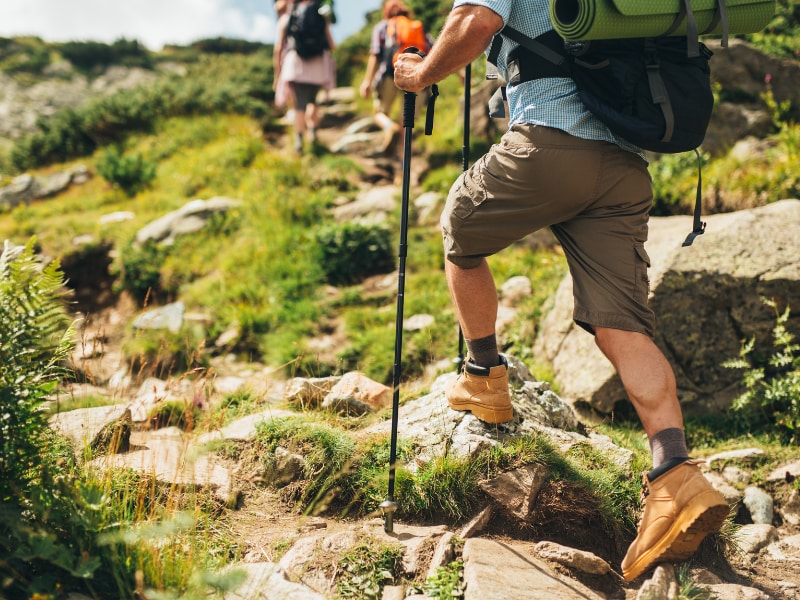 A group of people hiking on a rocky hill
