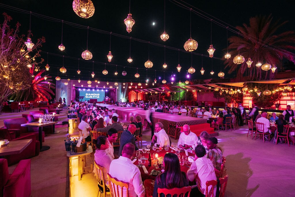 A group of people sitting at tables in a restaurant